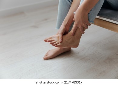 Closeup Shot Of Pain Leg Foot Suffering Tanned Beautiful Young Asian Woman Touch Ankle At Home Interior Living Room. Injuries Poor Health Illness Concept. Cool Offer Banner