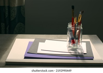 Closeup Shot Of Painter's Tools, Empty Blank Canvas, Brushes And Tube Of Oil Paint 