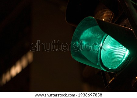 Closeup shot of a part of a traffic light, with green light turned on