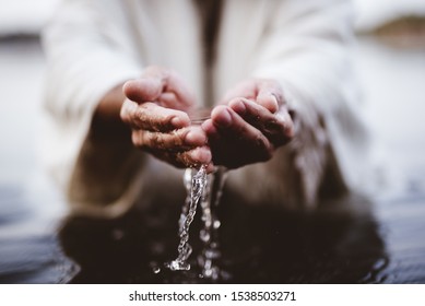 A closeup shot of a person drinking water with his hands with a blurred background - Shutterstock ID 1538503271