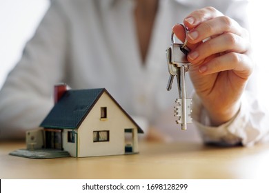 A closeup shot of a person thinking of buying or selling a house