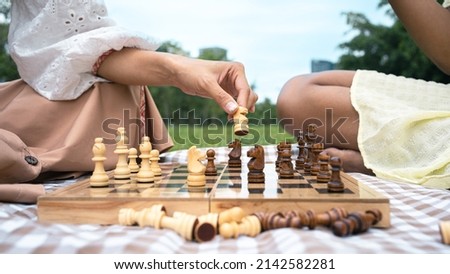 Close-up shot of playing chess between friends of different nationalities,Africans and Asians.
Multi ethnic activities in the park.
Training strategies,planning, spending time on a picnic.horse Board.