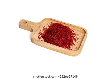 A close-up shot of premium saffron threads neatly arranged on a wooden tray against a white background. The vibrant red saffron strands create a striking contrast with the natural wood. - Powered by Shutterstock