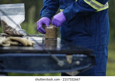 A Closeup Shot Of The Professional Worker Testing And Sampling Oil Sands Tailing Ponds