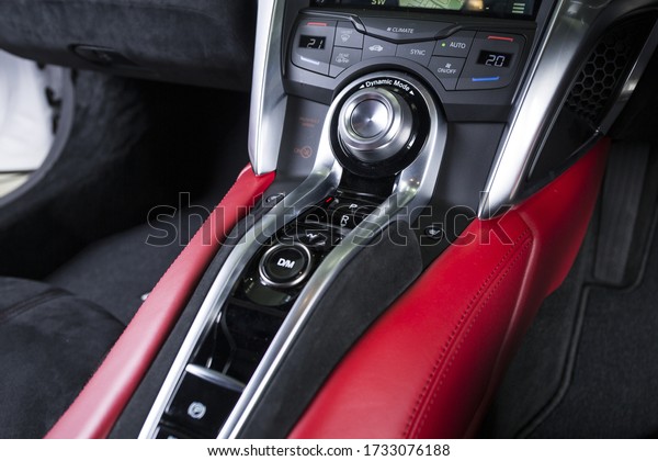 A closeup shot of red and black interior details of a\
modern luxury car