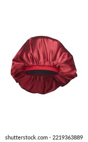 Close-up shot of a red sleep cap with a wide elastic band. A satin hair bonnet for protecting hair at night is isolated on a white background. Front view.