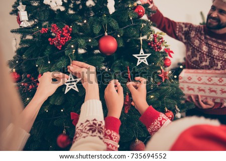 Closeup shot of relatives at home in knitted traditional costumes, ready to celebrate x mas eve. Happiness, friendship, parenthood, childhood, upbringing, unity, help, mother, father