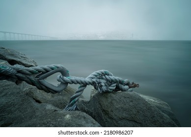 A Closeup Shot Of A Rope On A Dark Sea View In Norway