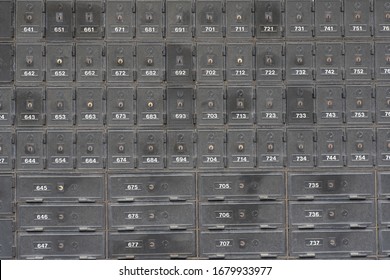 A Closeup Shot Of Rows Of Old Numbered Safe Deposit Boxes