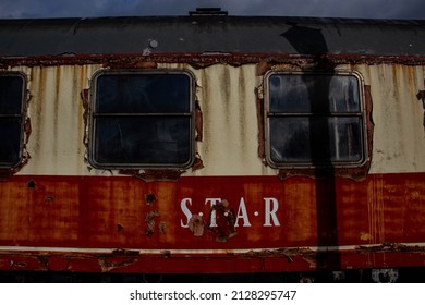 A closeup shot of rusted and abandoned, old train station wagon