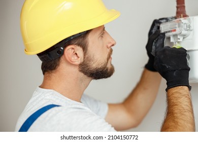 Closeup Shot Of Serious Heating Fitter Checking Gas Consumption At Gas Pipe And Meter Counter