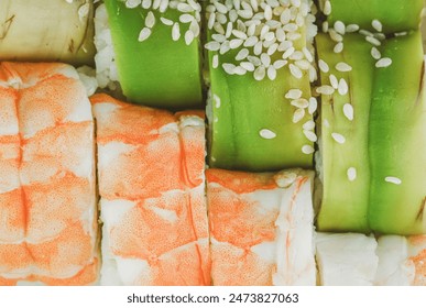 A close-up shot of several freshly made sushi rolls with shrimp, avocado, and sesame seeds. - Powered by Shutterstock