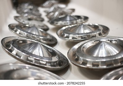 A closeup shot of shiny metal chrome hubcaps