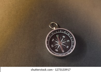 Closeup shot of a shiny metalic compass pointing always to magnetic North