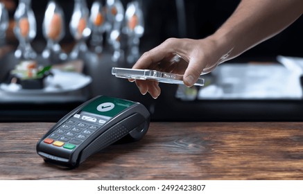 A close-up shot shows a hand holding a smartphone near a payment terminal, ready to complete a transaction. The scene emphasizes the themes of finance,  and contactless payment technology - Powered by Shutterstock