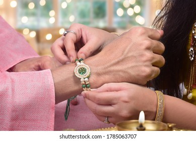 Closeup shot of sister tying rakhi on her brother's wrist, raksha bandhan - Shutterstock ID 1785063707