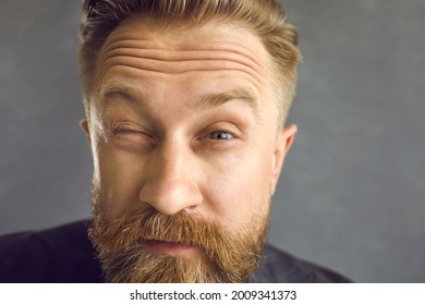 Closeup shot skeptical handsome bearded man looking at you with expression of suspicion, doubt and disbelief on face isolated on grey background. Suspicious angry boss watching his employees at work - Powered by Shutterstock