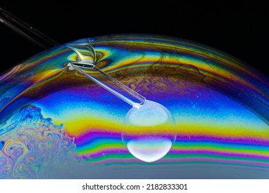 Close-up Shot Of Soap Bubble Created Inside Another With Plastic Tubing