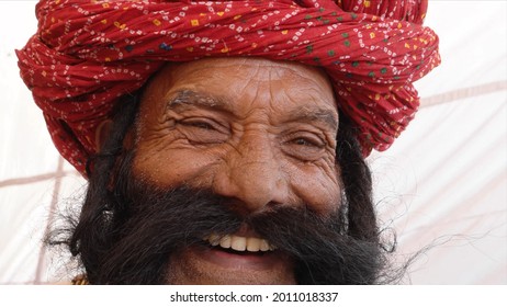 A Closeup Shot Of A South Asian Old Man With A Long Beard Smiling