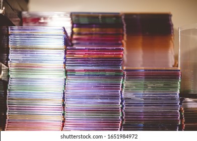 A closeup shot of a stack of CDs on a blurred background