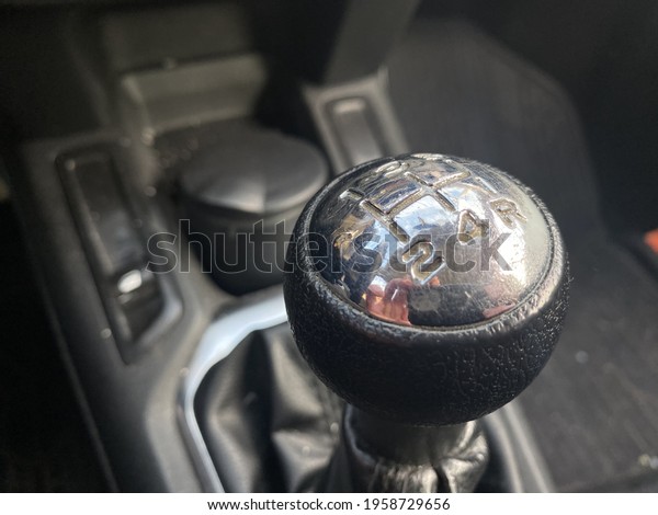 A closeup\
shot of a stick shift in a manual\
car