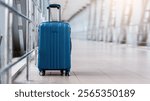 Closeup Shot Of Stylish Cabin Baggage Suitcase Standing In Empty Airport Hall, Blue Hand Luggage Bag Waiting At Terminal, Advertisement Banner For Air Travels And Flight Bookings, Copy Space