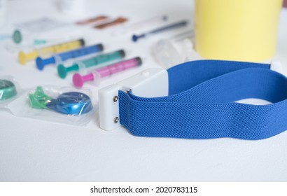 A Closeup Shot Of Syringes And A Tourniquet