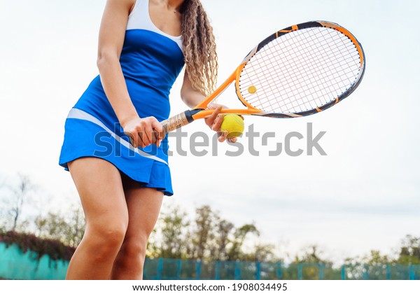 A close-up shot of a tennis ball and racket. The\
tennis player prepares to serve during the match. A beautiful sport\
that requires physical, emotional and mental preparation. Selective\
focus