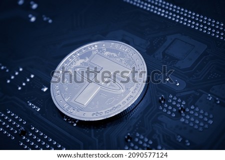 Closeup shot of tether coin over motherboard