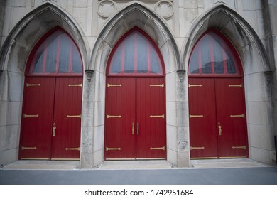 A Closeup Shot Of Three Red Doors With Arcs In Columbia, MO