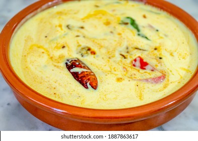 Closeup Shot Of Tomato Buttermilk Curry In An Clay Bowl