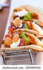 A Closeup Shot Of Traditional Mexican Tacos With Meat And Vegetables At A Beach Bar