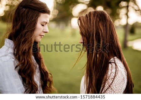 Similar – 2 young women sitting opposite each other