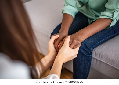 Closeup shot of two unrecognizable people holding hands in comfort. Be the person who helps the next. I'm here to support you. Black and White Hold Hands for Africa Union Peace Love - Shutterstock ID 2028098975