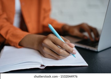 Closeup shot of university student hand using pen and writing in notebook, exam preparation, presentation, working project at workplace. Education concept. Woman taking notes, typing on keyboard  - Shutterstock ID 1532044976