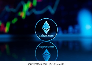 A closeup shot of a vertically positioned Ethereum coin in the blurry background of stock images