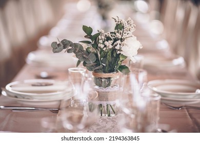 A Closeup Shot Of A Wedding Table Decoration With Simple Small Bouquet