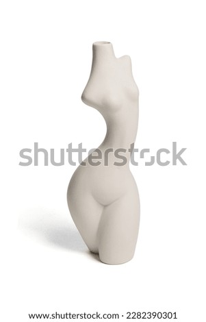 Close-up shot of a white empty ceramic female body shaped vase with a narrow neck isolated on a white background. Modern home decor element. Front view.