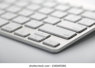 Closeup shot of white keyboard on white background.