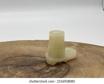 A closeup shot of a white machine element on a wooden background