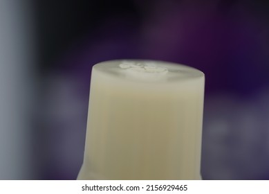 A closeup shot of a white machine element on a blurred background