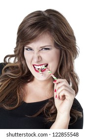 Close-up shot of woman biting a candy cane