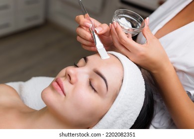 Close-up shot of a woman getting facial treatment with clay mask. Cosmetology and spa - Powered by Shutterstock