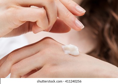 Closeup Shot Of Woman Hands Applying Moisturizing Hand Cream