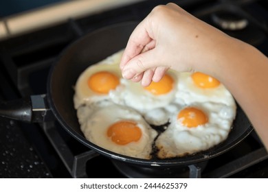 Close-up shot of a woman preparing scrambled eggs for breakfast	 - Powered by Shutterstock