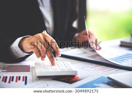Close-up shot of woman pressing a calculator to review and summarize the cost of mortgage home loans for refinancing plans, lifestyle concept.