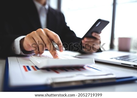 Close-up shot of woman pressing a calculator to review and summarize the cost of mortgage home loans for refinancing plans, lifestyle concept.