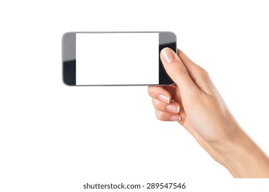 Closeup Shot Of A Woman Showing Modern Mobile Phone Isolated On White Background. Girl Holding A Smartphone With White Screen In Horizontal. Young Woman's Hand Showing An Horizontal Cellphone.