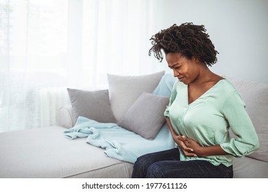 Closeup Shot Of A Woman Suffering With Stomach Cramps At Home. Abdominal Pain Patient Woman Having Medical Exam With Doctor On Illness From Stomach Cancer, Irritable Bowel Syndrome