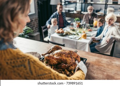 Close-up Shot Of Woman With Thanksgiving Turkey For Holiday Dinner With Family